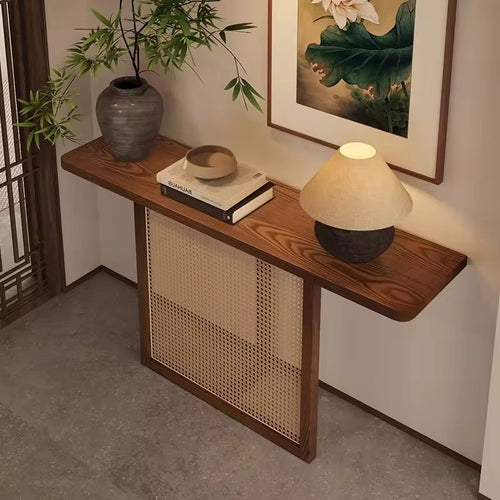The Opah Foyer Console is an elegant celebration of material harmony, where natural textures meet refined craftsmanship. Designed for homes that embrace warmth and restraint, this console features handwoven rattan detailing framed within a solid teak border, paired with a rich teak veneer top that adds depth and timeless character.