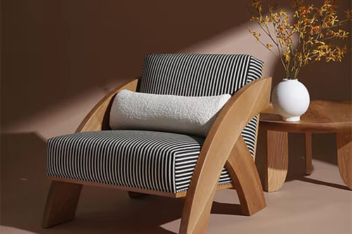 Explore the Orloz Teak Accent Chair, a luxury accent chair crafted in solid teak with a bold sculptural design. Perfect for modern living rooms and premium interiors.