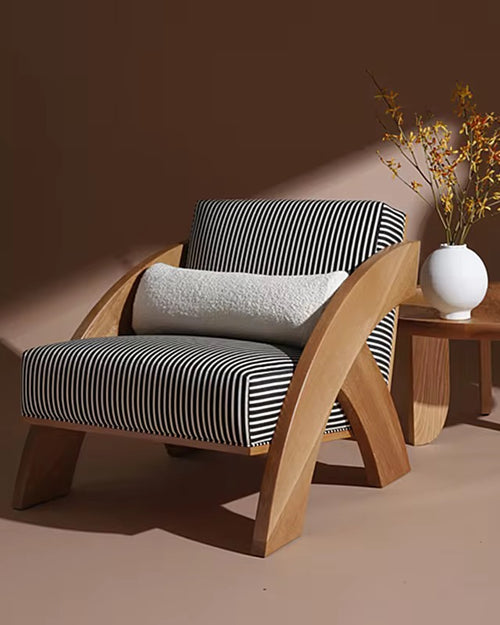 Explore the Orloz Teak Accent Chair, a luxury accent chair crafted in solid teak with a bold sculptural design. Perfect for modern living rooms and premium interiors.