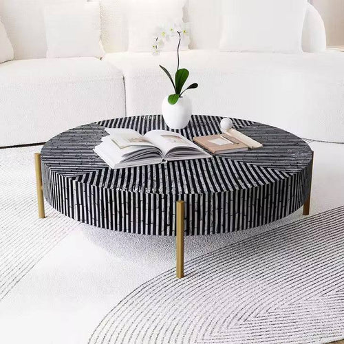 Round coffee table with black and white striped design