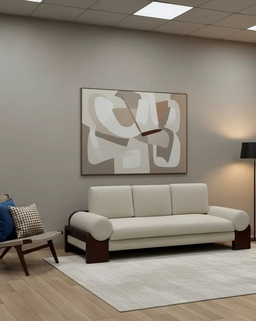 Modern statement sofa featuring a solid teak wood frame, plush upholstered seat and back cushions, and rounded arm bolsters for contemporary luxury interiors.