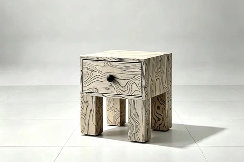 Pocho Bedside Table featuring expressive black and white abstract wood grain veneer, a single drawer with a black knob, and chunky sculptural wooden legs.