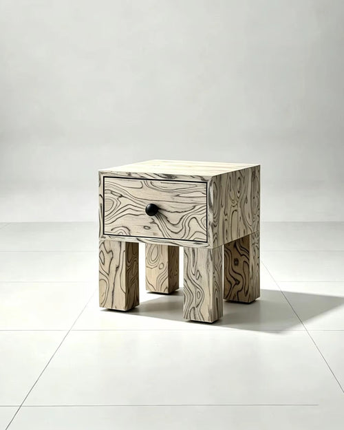 Pocho Bedside Table featuring expressive black and white abstract wood grain veneer, a single drawer with a black knob, and chunky sculptural wooden legs.