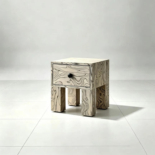 Pocho Bedside Table featuring expressive black and white abstract wood grain veneer, a single drawer with a black knob, and chunky sculptural wooden legs.