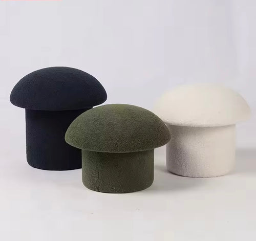 modern sculptural pouf stool upholstered in fabric for living room seating