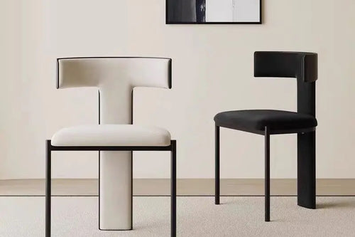 Two Regalia chairs, one upholstered in white and one in black