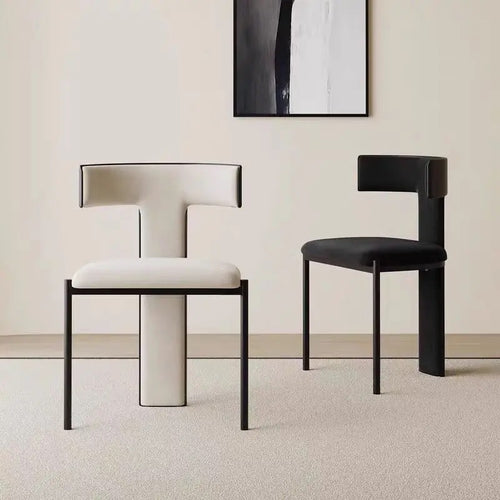 Two Regalia chairs, one upholstered in white and one in black