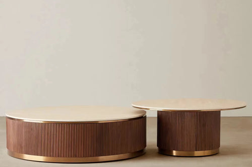 The Sorentino Coffee Table is a refined statement of material richness and sculptural balance, designed for interiors that value understated opulence. Featuring a travertine stone top set atop a fluted teak wood base, finished with subtle golden metal accents, Sorentino brings together texture, tone, and craftsmanship in perfect harmony.