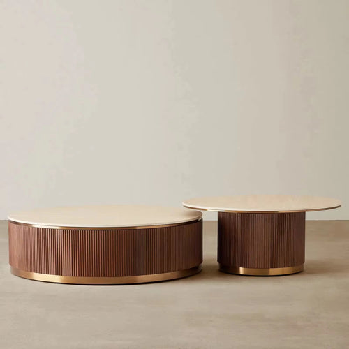 The Sorentino Coffee Table is a refined statement of material richness and sculptural balance, designed for interiors that value understated opulence. Featuring a travertine stone top set atop a fluted teak wood base, finished with subtle golden metal accents, Sorentino brings together texture, tone, and craftsmanship in perfect harmony.