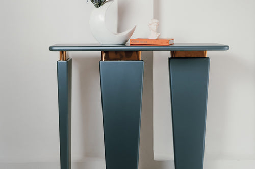 Terra console with asymmetrical legs and gold trim.