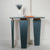 Terra console with asymmetrical legs and gold trim.