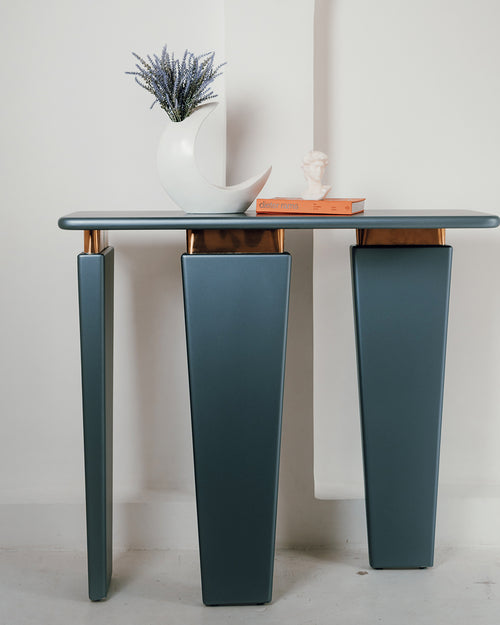 Terra console with asymmetrical legs and gold trim.