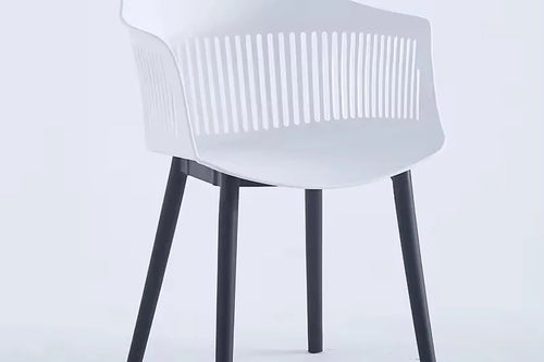 A white Toit chair with a round back and black legs.