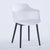 A white Toit chair with a round back and black legs.
