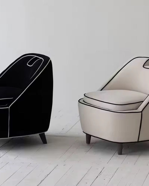 Black and cream piped lounge chairs pair