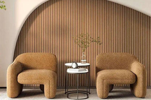 Two brown upholstered armchairs with a small round table