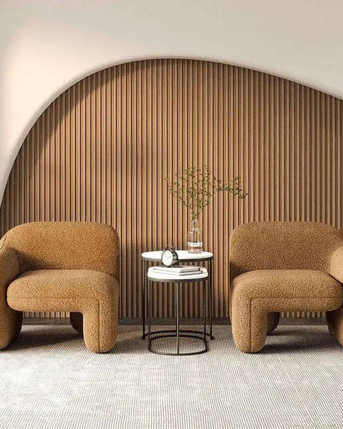 Two brown upholstered armchairs with a small round table