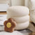 Unio Pouf in white, showing elegant ring design