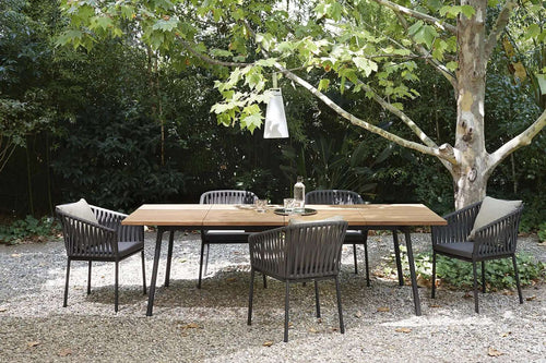 Wicker chairs around garden dining table