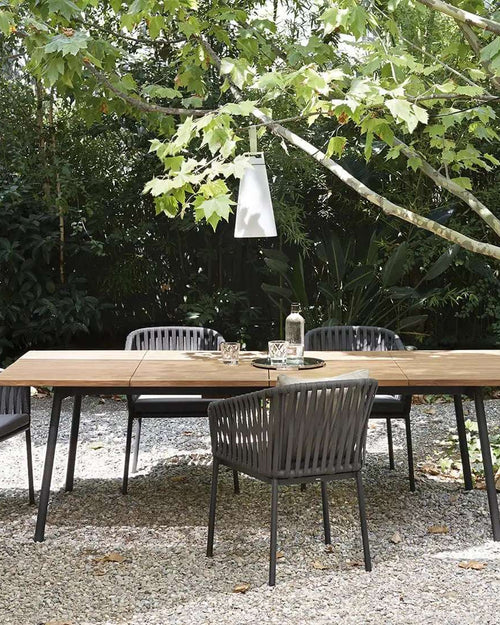 Wicker chairs around garden dining table