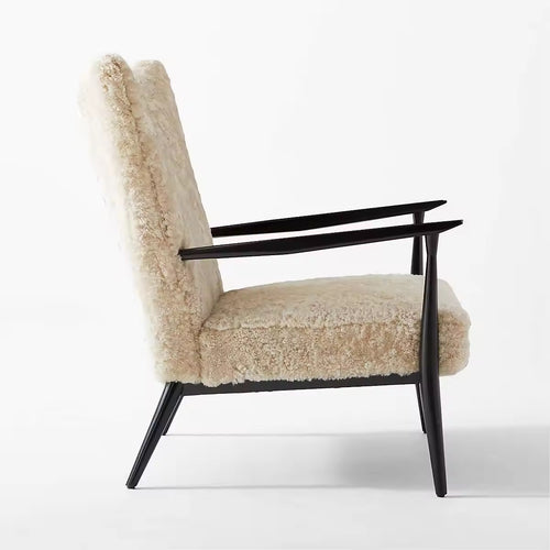 Side profile of Zephyr chair with winged back and black arms