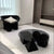 Black round coffee table in modern interior 