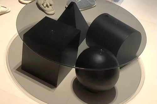 Modern black and glass coffee table with abstract design