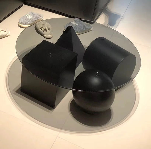 Modern black and glass coffee table with abstract design