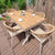 Wooden outdoor dining table with six wicker chairs