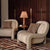 Two beige armchairs with patterned cushions