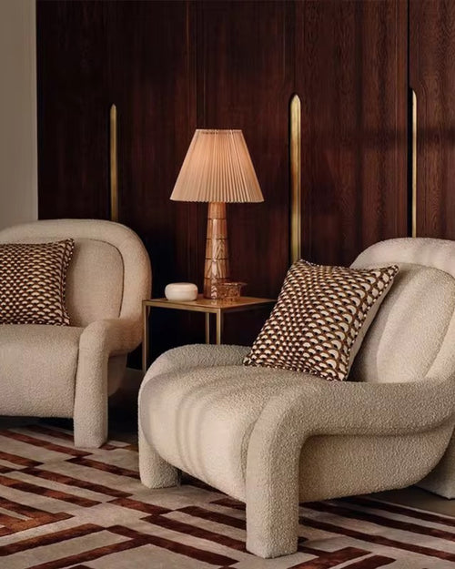 Two beige armchairs with patterned cushions
