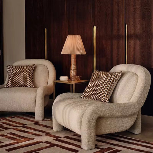 Two beige armchairs with patterned cushions